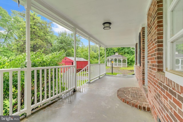 29823 Hillview Dr, Mechanicsville, MD 20659 - view of patio featuring a storage shed, an outdoor structure, and view of wooded area
