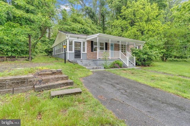 29823 Hillview Dr, Mechanicsville, MD 20659 - ranch-style house featuring covered porch, brick siding, and a front yard