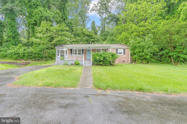 29823 Hillview Dr, Mechanicsville, MD 20659 - view of front of home with covered porch, crawl space, brick siding, and a front lawn