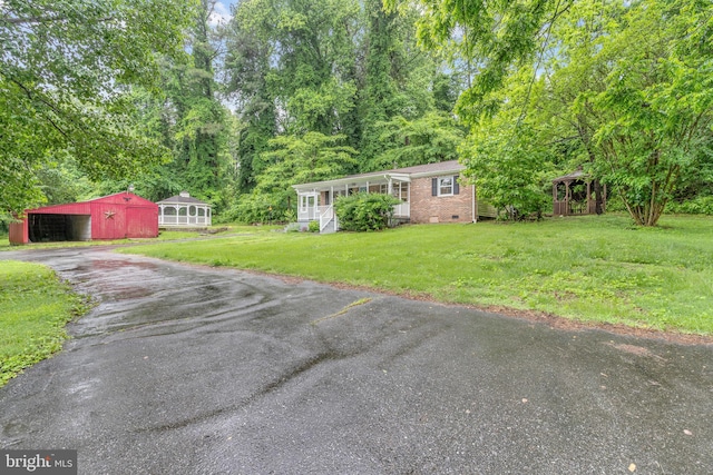29823 Hillview Dr, Mechanicsville, MD 20659 - view of green lawn featuring driveway, an outdoor structure, covered porch, and an outbuilding