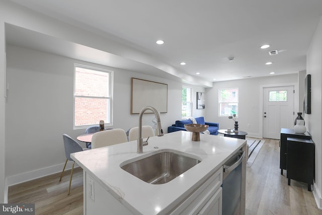 1456 Congress Pl SE, Washington, DC 20020 - kitchen featuring a sink, dishwasher, light wood-style floors, recessed lighting, and light stone counters
