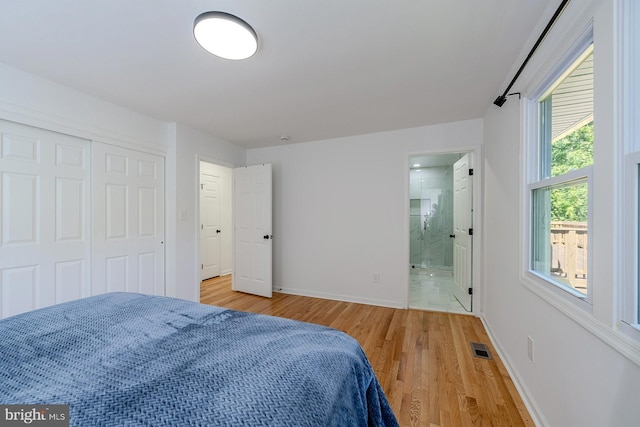 8601 Fort Dr, Manassas, VA 20110 - bedroom featuring light wood-style floors, baseboards, a closet, and ensuite bathroom