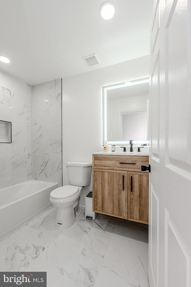 8601 Fort Dr, Manassas, VA 20110 - bathroom featuring vanity, toilet, marble look tiles, and  shower combination