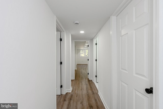 8601 Fort Dr, Manassas, VA 20110 - hallway with light wood-type flooring, baseboards, and recessed lighting
