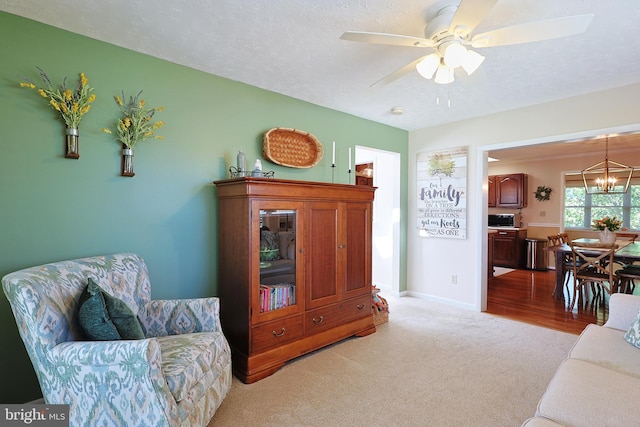 14600 Barton Blvd SW, Cresaptown, MD 21502 - living room featuring light colored carpet, a chandelier, ceiling fan, a textured ceiling, and baseboards