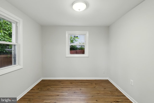 1208 Larchmont Ave, Capitol Heights, MD 20743 - empty room with plenty of natural light, wood finished floors, and baseboards