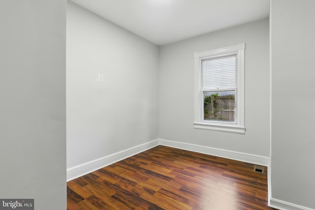 1208 Larchmont Ave, Capitol Heights, MD 20743 - unfurnished room featuring baseboards and dark wood-type flooring