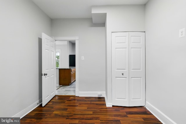 1208 Larchmont Ave, Capitol Heights, MD 20743 - unfurnished bedroom with wood finished floors, baseboards, and a closet