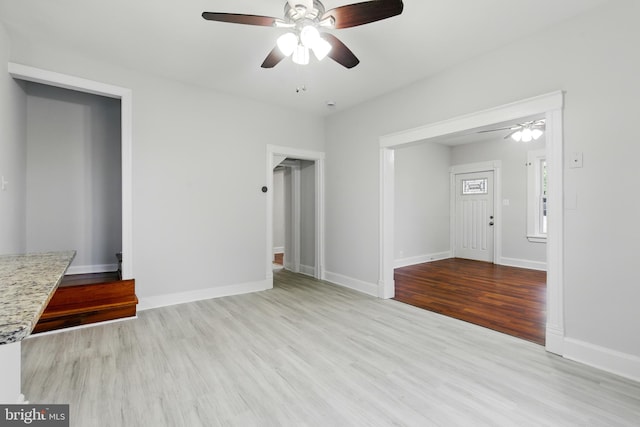 1208 Larchmont Ave, Capitol Heights, MD 20743 - unfurnished living room featuring ceiling fan, wood finished floors, and baseboards
