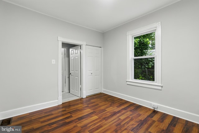 1208 Larchmont Ave, Capitol Heights, MD 20743 - unfurnished bedroom with wood finished floors, baseboards, and a closet