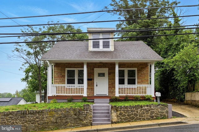 1208 Larchmont Ave, Capitol Heights, MD 20743 - view of front of house featuring stone siding, covered porch, and a shingled roof