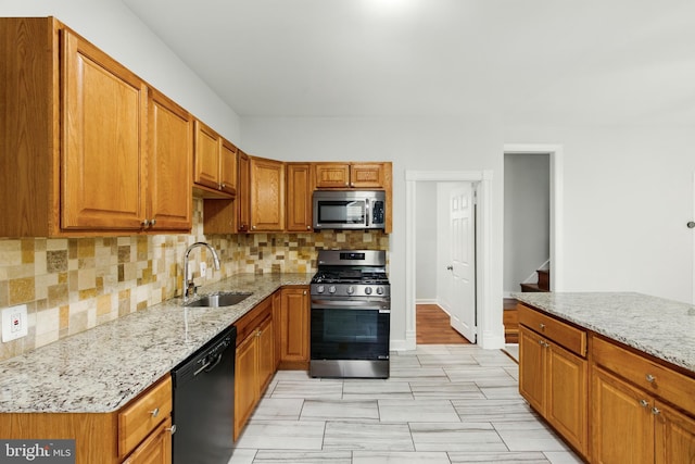 1208 Larchmont Ave, Capitol Heights, MD 20743 - kitchen with stainless steel appliances, a sink, light stone counters, and tasteful backsplash