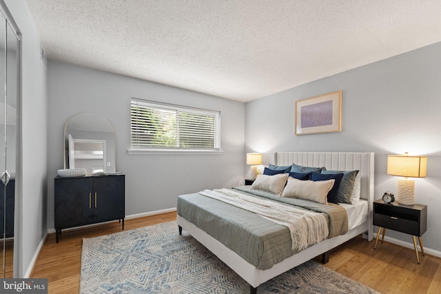 122 N Bedford St Unit A, Arlington, VA 22201 - bedroom with wood finished floors, a textured ceiling, and baseboards