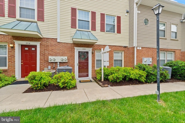 122 N Bedford St Unit A, Arlington, VA 22201 - townhome / multi-family property with central AC unit, brick siding, and a standing seam roof