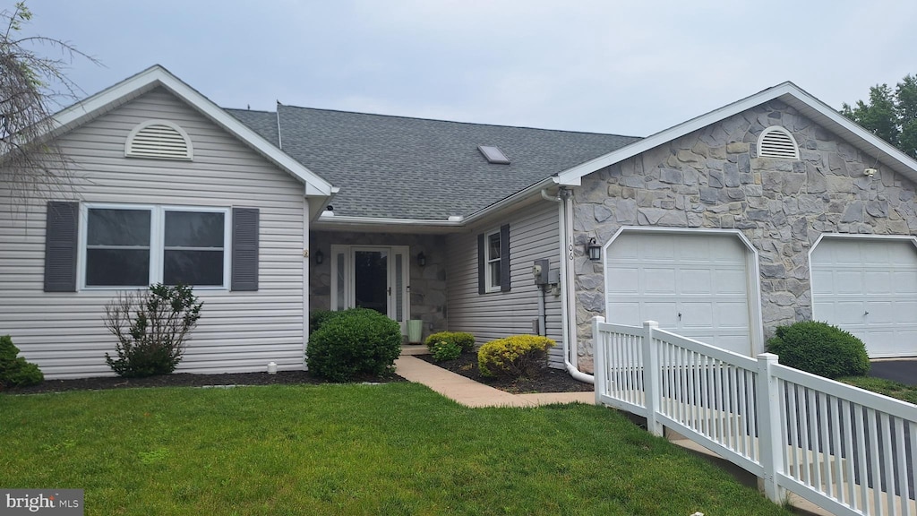 106 Sarah Ct, Lewisberry, PA 17339 - ranch-style home featuring an attached garage, stone siding, a front lawn, roof with shingles, and concrete driveway