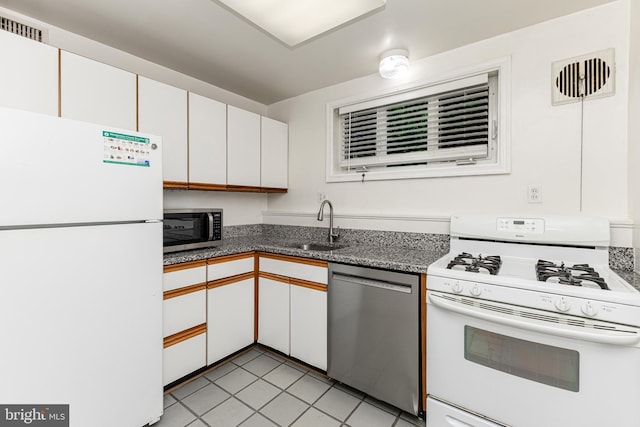 10401 Montrose Ave Unit 10401, Bethesda, MD 20814 - kitchen featuring appliances with stainless steel finishes, a sink, white cabinets, and light tile patterned floors