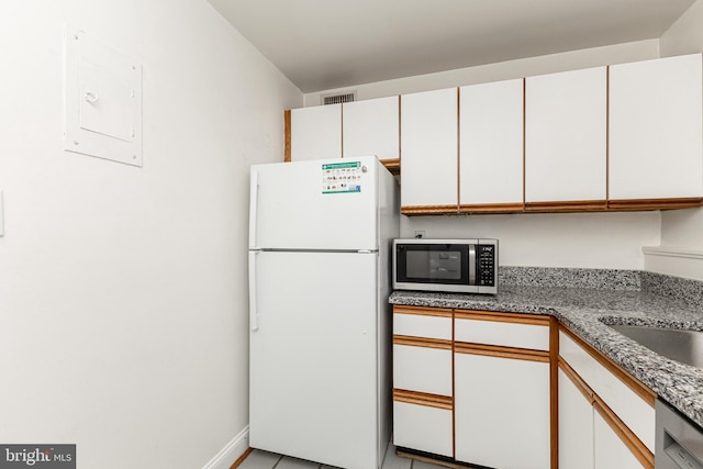 10401 Montrose Ave Unit 10401, Bethesda, MD 20814 - kitchen featuring stainless steel appliances, white cabinets, electric panel, baseboards, and light tile patterned floors