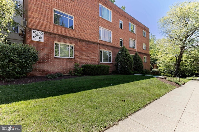 10401 Montrose Ave Unit 10401, Bethesda, MD 20814 - view of side of home featuring a yard and brick siding