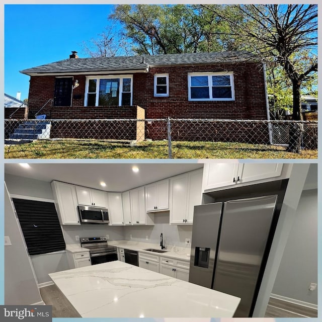5303 55th Pl, Riverdale, MD 20737 - kitchen featuring stainless steel appliances, a sink, baseboards, and white cabinets