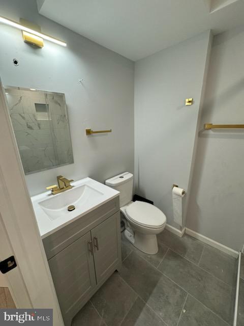 5303 55th Pl, Riverdale, MD 20737 - bathroom featuring toilet, vanity, tile patterned floors, and baseboards