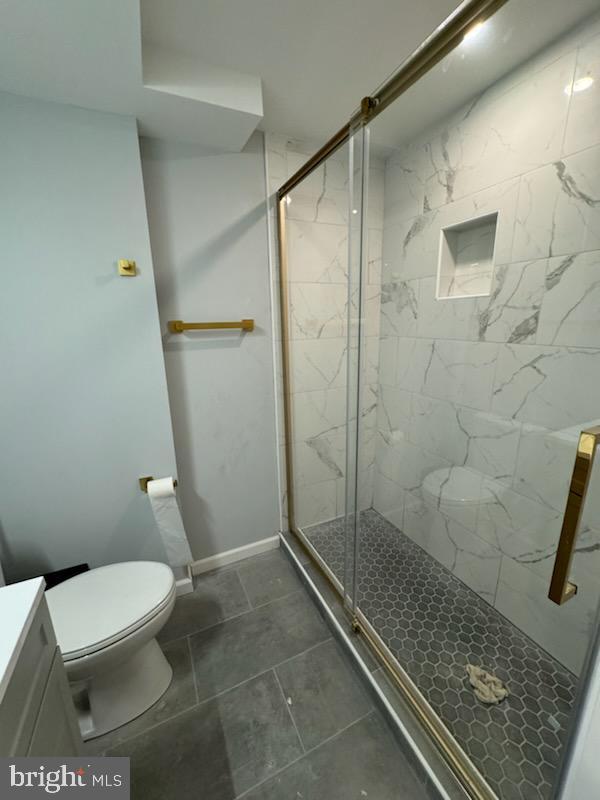 5303 55th Pl, Riverdale, MD 20737 - bathroom with toilet, a shower stall, vanity, and tile patterned floors