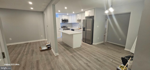 5303 55th Pl, Riverdale, MD 20737 - kitchen featuring appliances with stainless steel finishes, recessed lighting, light countertops, white cabinets, and a sink