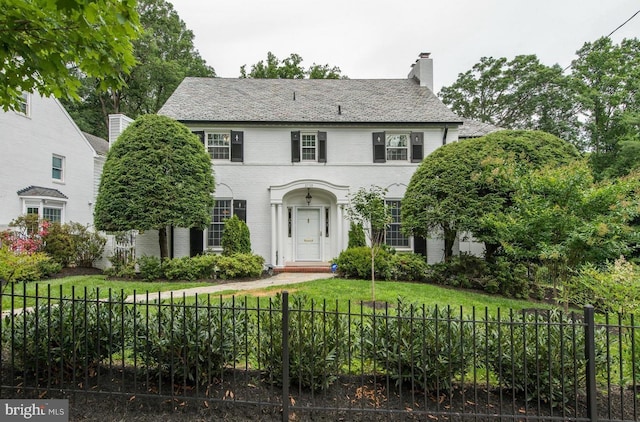 2739 Chesapeake St NW, Washington, DC 20008 - colonial-style house featuring a chimney, a high end roof, and brick siding