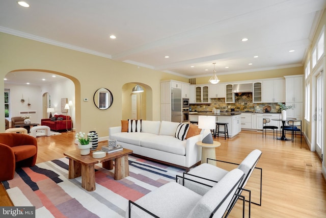2739 Chesapeake St NW, Washington, DC 20008 - living room with arched walkways, light wood-style floors, ornamental molding, recessed lighting, and baseboards