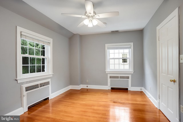 2739 Chesapeake St NW, Washington, DC 20008 - spare room with radiator, ceiling fan, light wood-style floors, and baseboards