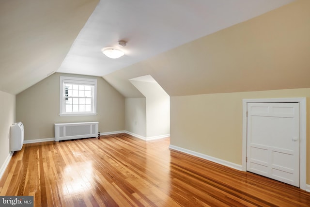 2739 Chesapeake St NW, Washington, DC 20008 - additional living space with radiator heating unit, light wood finished floors, vaulted ceiling, and baseboards