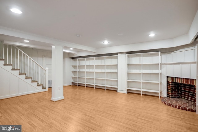 2739 Chesapeake St NW, Washington, DC 20008 - finished below grade area with wood finished floors, recessed lighting, crown molding, stairs, and a brick fireplace