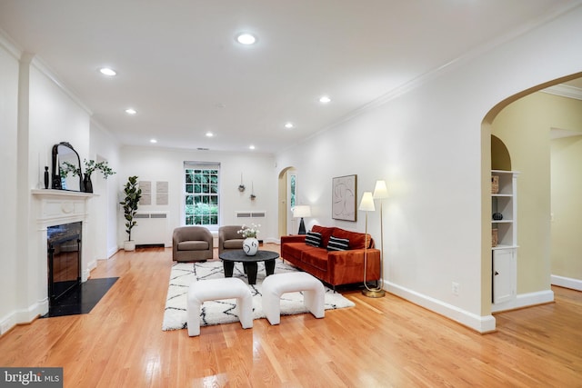2739 Chesapeake St NW, Washington, DC 20008 - living area with arched walkways, crown molding, light wood finished floors, recessed lighting, and a fireplace with flush hearth