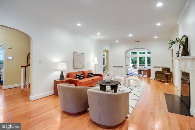 2739 Chesapeake St NW, Washington, DC 20008 - living room featuring arched walkways, ornamental molding, light wood-style floors, recessed lighting, and a fireplace