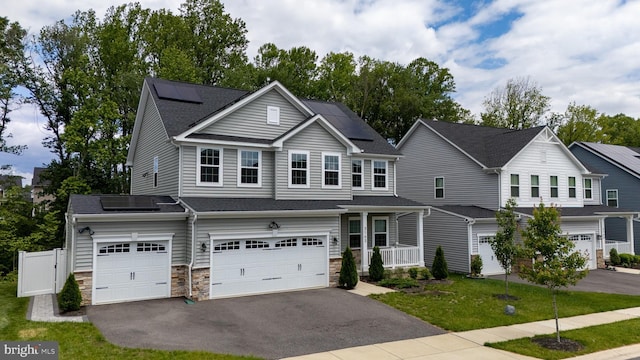 3163 Dodder Way, Odenton, MD 21113 - view of front of home with driveway, solar panels, a garage, and stone siding