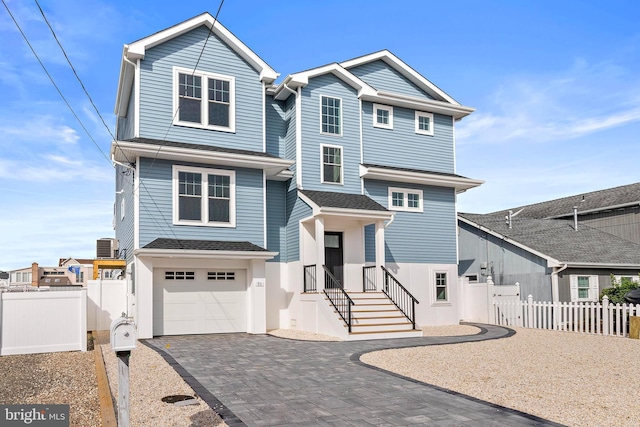 31 Phyllis Ln, Manahawkin, NJ 08050 - view of front of house featuring decorative driveway, a garage, fence, and a gate