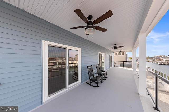 31 Phyllis Ln, Manahawkin, NJ 08050 - view of patio with a ceiling fan, a water view, and a balcony