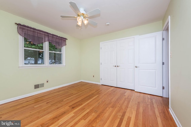 611 N Ct, Linthicum Heights, MD 21090 - unfurnished bedroom with light wood-style floors, baseboards, a closet, and ceiling fan