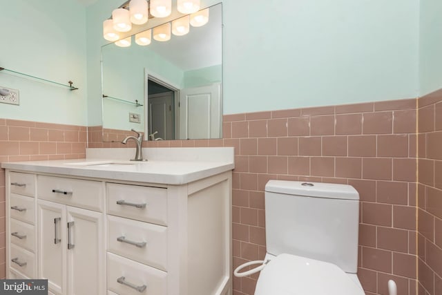 611 N Ct, Linthicum Heights, MD 21090 - bathroom with tile walls, vanity, toilet, and wainscoting