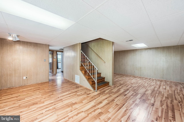 611 N Ct, Linthicum Heights, MD 21090 - basement featuring wood finished floors, a paneled ceiling, stairs, and wooden walls