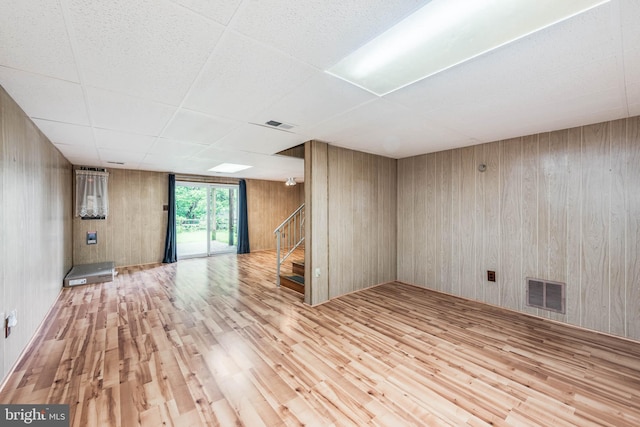 611 N Ct, Linthicum Heights, MD 21090 - empty room with wood finished floors, stairs, wooden walls, and a paneled ceiling