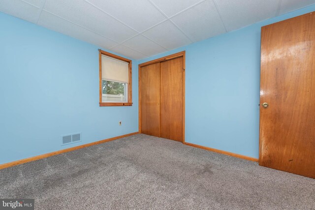 611 N Ct, Linthicum Heights, MD 21090 - unfurnished bedroom with carpet floors, baseboards, a closet, and a drop ceiling