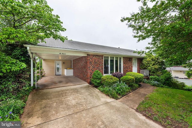 611 N Ct, Linthicum Heights, MD 21090 - view of front of property featuring brick siding, an attached carport, driveway, and roof with shingles