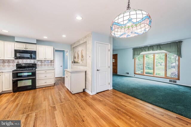 611 N Ct, Linthicum Heights, MD 21090 - kitchen with black appliances, light countertops, white cabinets, light wood-style floors, and baseboards