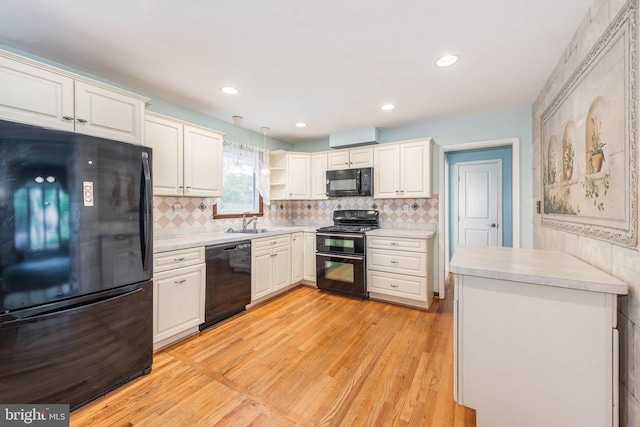 611 N Ct, Linthicum Heights, MD 21090 - kitchen featuring black appliances, light countertops, open shelves, light wood finished floors, and recessed lighting