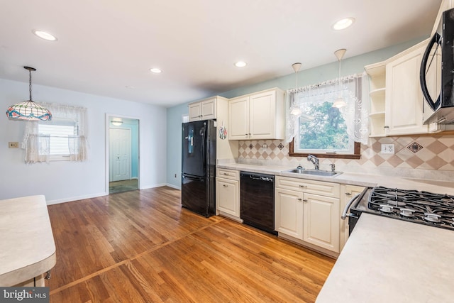 611 N Ct, Linthicum Heights, MD 21090 - kitchen featuring black appliances, a sink, light countertops, decorative light fixtures, and recessed lighting