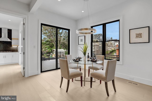 dining room with baseboards, recessed lighting, and light wood-style floors