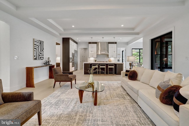 living room with a tray ceiling and recessed lighting