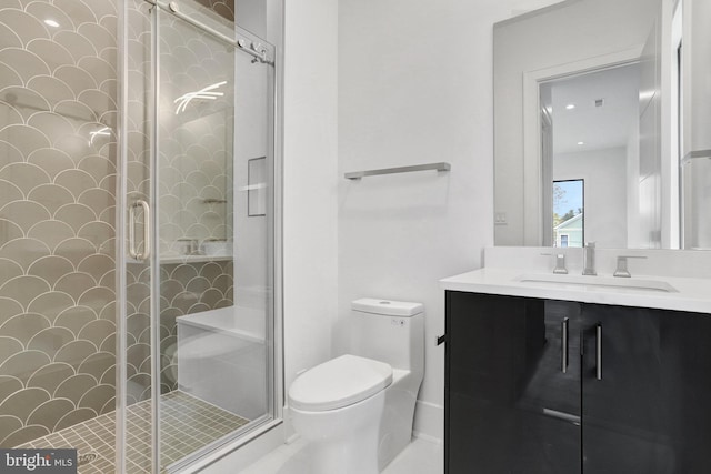 full bathroom featuring toilet, a stall shower, and vanity