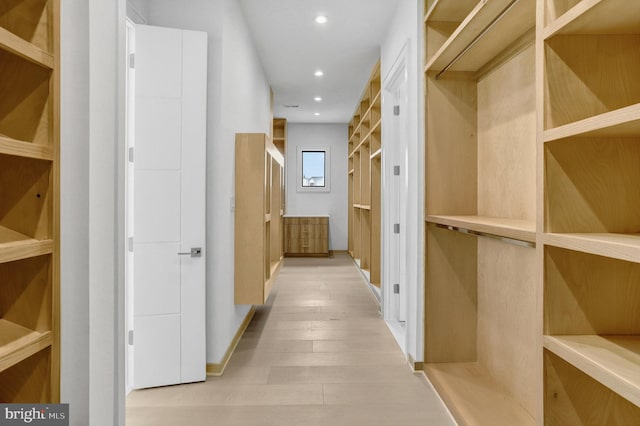 hall with recessed lighting and light wood-style flooring