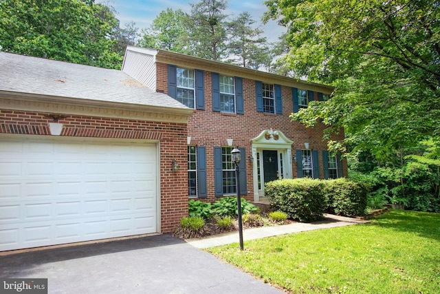 13076 Dove Tree Ct, Manassas, VA 20112 - view of front of home featuring brick siding, an attached garage, driveway, and a front yard